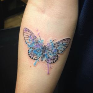 Express your beauty with a colorful watercolor butterfly tattoo on your forearm by Aygul. Stand out from the rest!