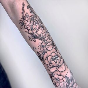 Get a stunning floral tattoo in white ink on your forearm in London, GB. Stand out with this unique and delicate design.