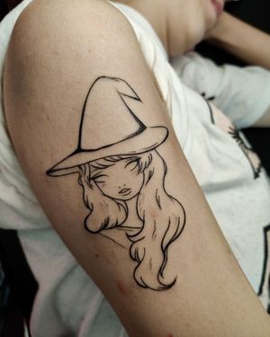 Captivating black and gray fine line tattoo featuring a witch wearing a hat, created by the talented artist Mary Shalla.