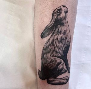 Capture the beauty of nature with a stunning black and gray hare tattoo on your forearm. Get inked in London, GB.