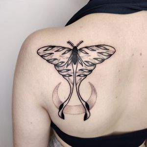 Get a unique dotwork tattoo of a moon and moth on your shoulder in London. Expertly done by a skilled tattoo artist.