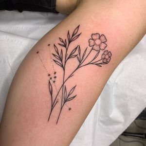 Capture the beauty of nature with this illustrative tattoo featuring delicate flowers and leaves, expertly crafted by tattoo artist Chris Harvey.