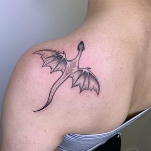 Get an intricate dotwork dragon tattoo on your shoulder in London, showcasing a unique and mesmerizing design.