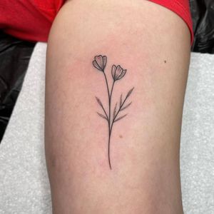 Elegant upper arm tattoo featuring a detailed dotwork and fine line illustrative design of a beautiful flower sprig, created by the talented artist Chris Harvey.