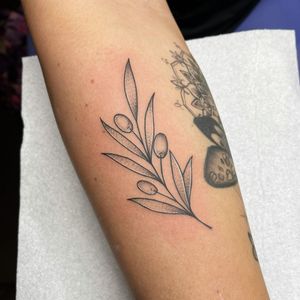 Elegant and delicate, this forearm tattoo by Chris Harvey features a beautiful leaf design executed in fine line illustrative style.