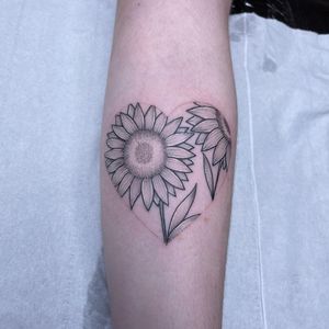 Illuminate your forearm with a beautiful dotwork and fine line illustrative tattoo featuring a sunflower and heart design by Chris Harvey.
