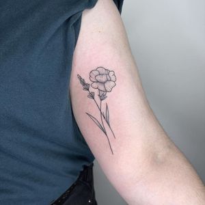 Adorn your upper arm with a fine line, illustrative floral design crafted with intricately detailed dotwork by the talented artist Chris Harvey.