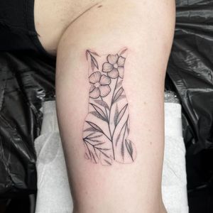 Elegant upper arm tattoo by Chris Harvey featuring a detailed cat and flower design in fine line illustrative style