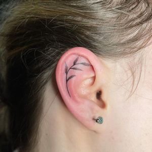 Get an intricate dotwork sprig design inked on your ear in London. Unique and delicate tattoo art!