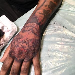 Exquisite blackwork foo dog tattoo on forearm by tattoo artist Frankie Brown.