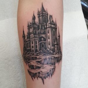 Capture the enchantment with this blackwork castle tattoo by Dani Mawby on your forearm. A timeless piece of art.
