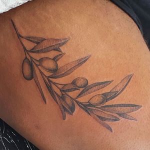 Elegant floral design featuring delicate olive leaves, perfect for upper leg placement in London, GB.