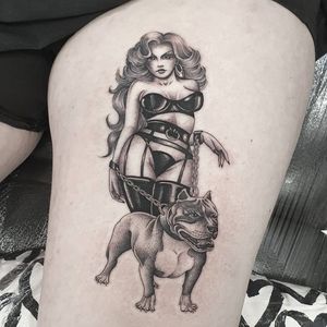 Detailed illustrative tattoo on upper leg by Dani Mawby featuring a dog, woman, chain, and collar design.