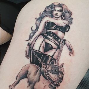 Get a unique chicano tattoo of a dog and lady on your upper leg in London, GB. Embrace the Chicano culture with this classic design.
