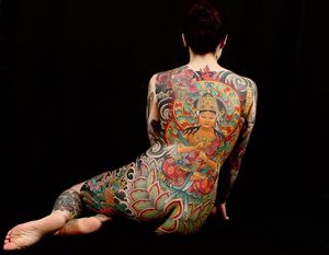 An intricate and bold Japanese-themed back piece tattoo featuring a beautiful woman holding a sword, expertly crafted by tattoo artist Stewart Robson.