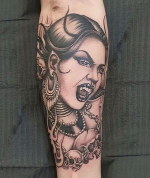 Get a stylish chicano design of a vampire woman tattooed on your forearm in London, GB. Perfect mix of elegance and edge.