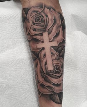 Discover the beauty of blackwork with this illustrative tattoo featuring a flower and cross design by Dani Mawby.