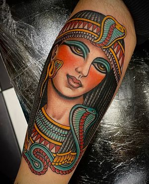 Capture the mystique of London with this stunning arm tattoo featuring a neo-traditional woman and sphynx design.