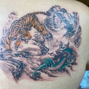 Tiger and Dragon Chinese painting style. My first tattoo!