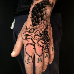 Get a unique black and gray new school snake tattoo on your hand in London for a bold and edgy look.