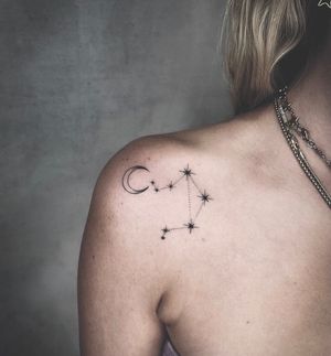 Get a fine line moon and stars tattoo on your shoulder in Los Angeles, a trendy and artistic choice for celestial ink lovers.