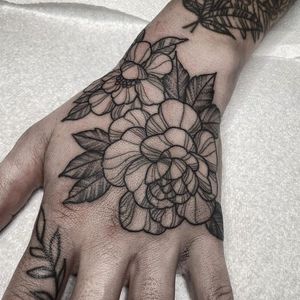 Embrace the beauty of nature with a stunning floral peony tattoo on your hand in London, GB.