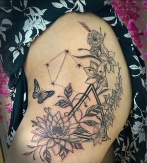 Floral thigh tattoo with birth flowers 