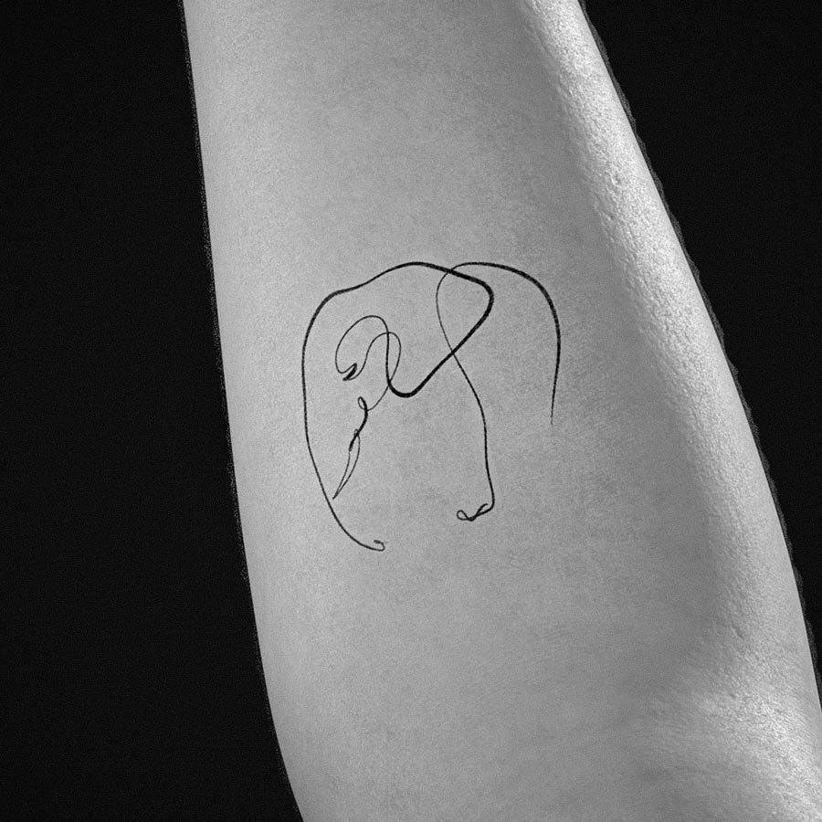 Minimalist line art elephant tattoo on the inner arm