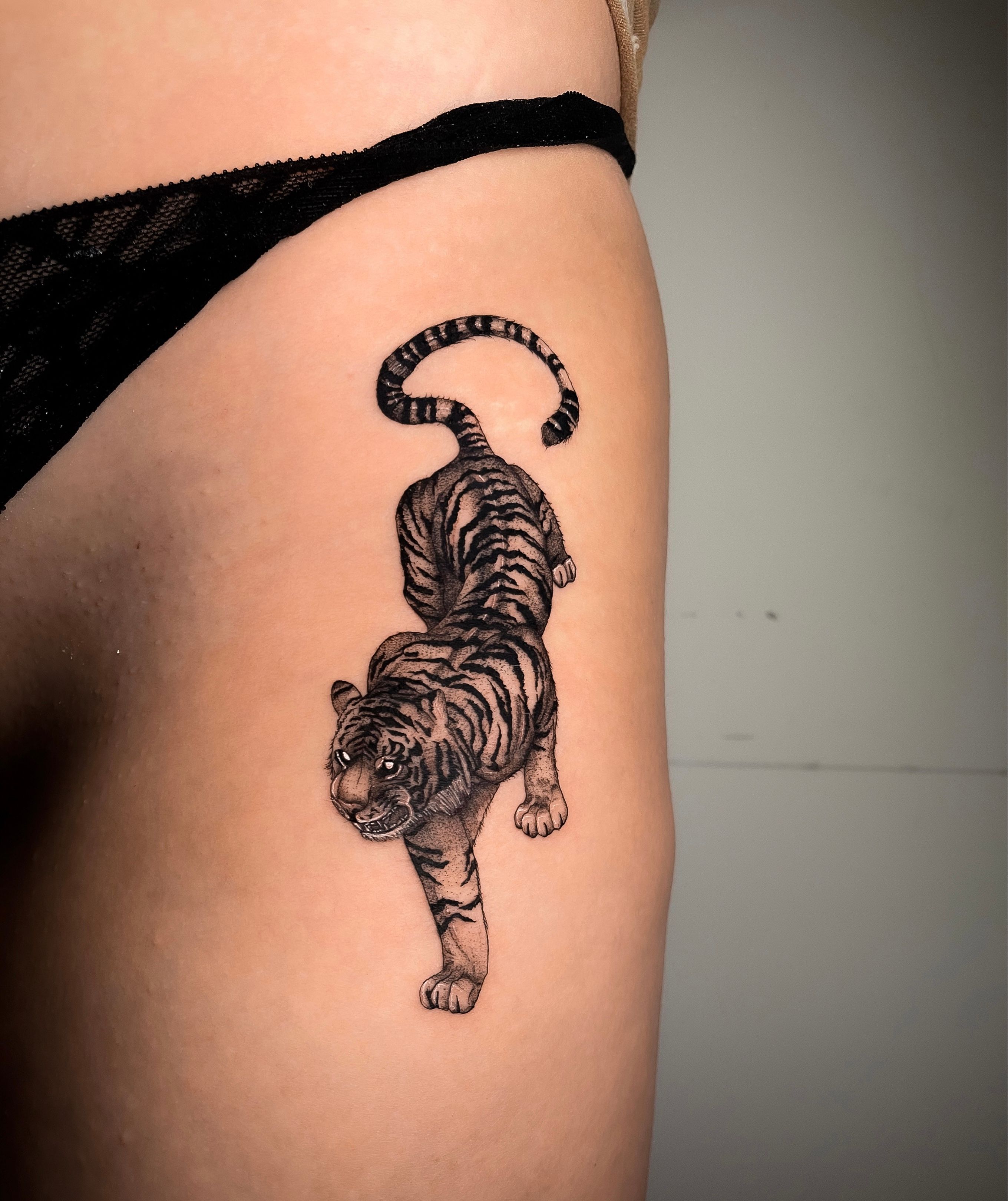 Tiger tattoo located on the hip