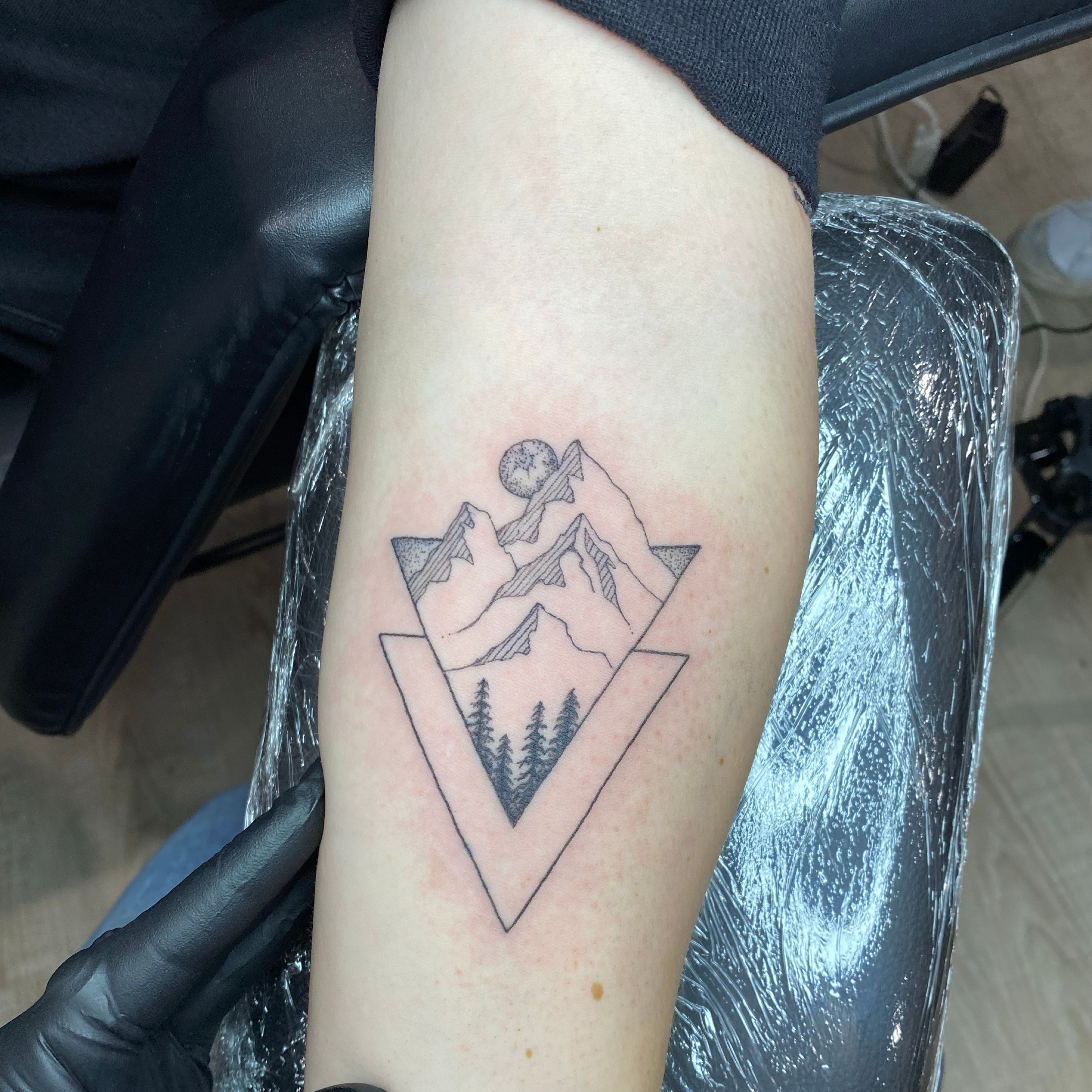 Mountain tattoo located on the inner forearm.