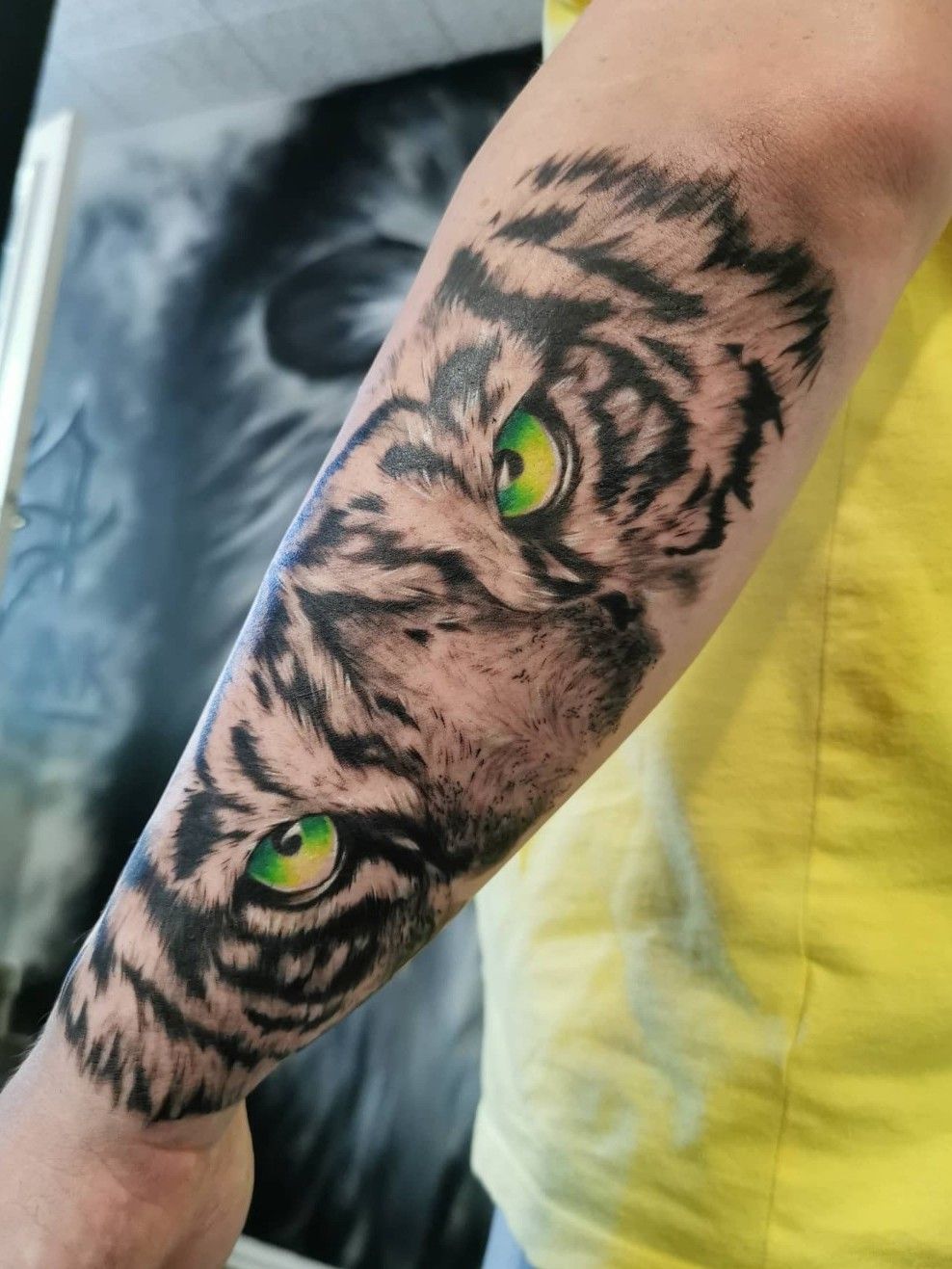 Black and grey style tiger tattoo on the right forearm