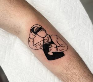 Blackwork tattoo featuring a man with a helmet holding a screwdriver, by Miss Vampira. Suitable for the lower leg.