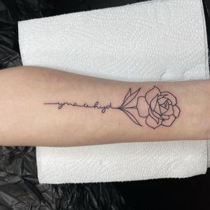 Elegant flower design with small lettering on forearm. Delicately illustrated in fine line style by the talented artist Chris Harvey.