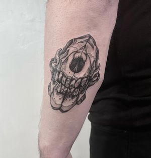 Get inked with a stunning black and gray upper arm tattoo featuring a detailed skull and skeleton motif by the talented artist Lou. W.