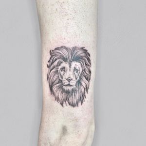 Experience the power and majesty of the lion with this black and gray illustrative tattoo by Lou. W. Perfect for those seeking a bold and detailed arm piece.