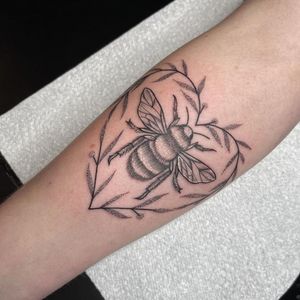 Unique dotwork and fine line design by Chris Harvey featuring a bee, heart, and sprig on the forearm.