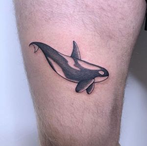 Experience the beauty of the ocean with this stunning fine line whale tattoo on your upper leg by Chris Harvey.