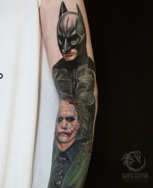 Get an epic new school tattoo featuring Heath Ledger's Joker facing off against Batman in a realistic illustrative style. Located in London, GB.