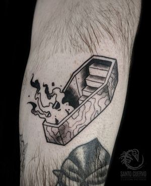 Get inked with a stunning black and gray coffin tattoo on your lower leg in London, GB. Make a bold statement with this edgy and timeless design.