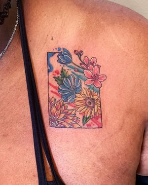 Get a stunning illustrative watercolor flower tattoo on your chest in the artistic city of New York for a unique and vibrant body art experience.