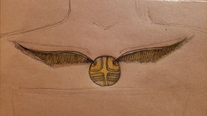 Hoping to get this (or something similar) tattooed someday. Description: Golden Snitch from Harry Potter with its wings splayed out along the collar bone.