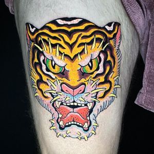 Get a fierce and vibrant tiger tattoo in neo traditional style on your upper leg in Miami. Stand out with this striking design!