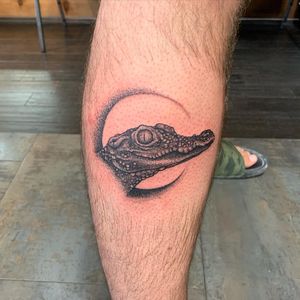 Get a fierce and detailed blackwork aligator tattoo on your lower leg in Miami, US. Perfect for bold and adventurous individuals!