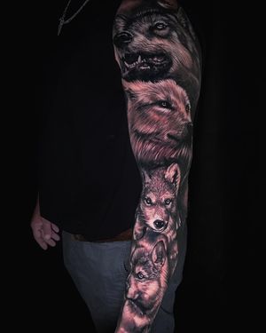 Get a stunning blackwork wolf sleeve tattoo in Miami combining realism and illustrative styles.