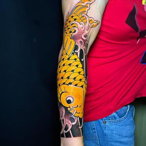 Immerse yourself in a sea of intricate waves and vibrant koi fish in this stunning Japanese sleeve tattoo by renowned artist Ami James.