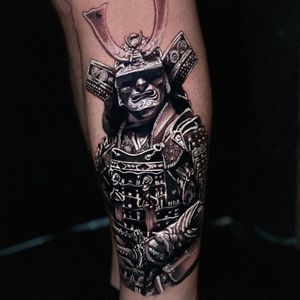 Get an intricate blackwork and realistic samurai helmet tattoo on your lower leg in Miami for a bold and striking look.