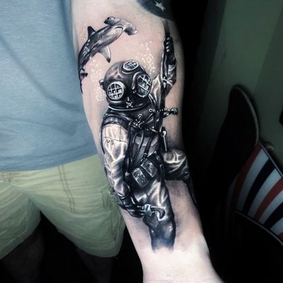 Intricate blackwork forearm tattoo featuring a shark, diver, and helmet, capturing the essence of Miami's marine life.