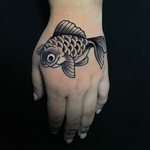 Get a striking blackwork fish tattoo on your hand in Miami, showcasing intricate illustrative details.