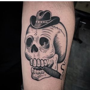 Get inked with a unique blackwork forearm tattoo featuring a skull wearing a hat and smoking a cigar, inspired by the Miami vibe. Stand out with this illustrative design!