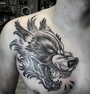 Get a unique blackwork wolf tattoo by Rico Dionichi on your chest for a bold and artistic statement.